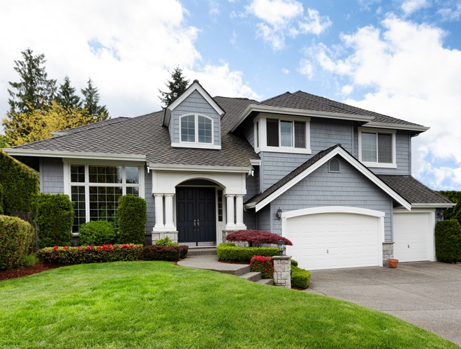 Clean home with healthy front yard during late spring season